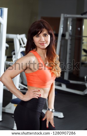 A young woman is engaged in a gym.