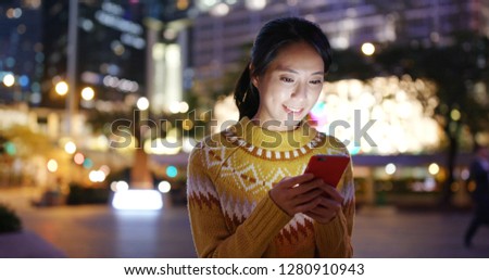 Woman use of mobile phone at the street
