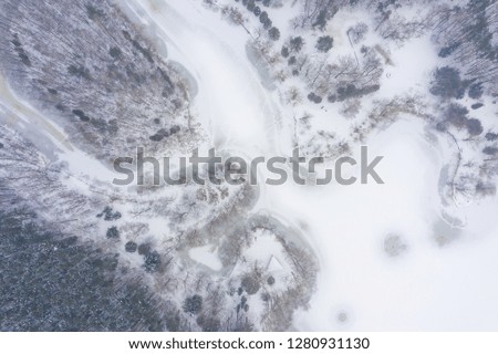 Aerial view of frozen lake.  Winter scenery. Landscape photo captured with drone above winter wonderland. Poland.