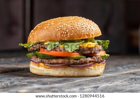 Perfect hamburger classic burger american cheeseburger with cheese, bacon, tomato and lettuce Royalty-Free Stock Photo #1280944516
