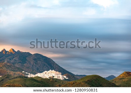 Mojacar old Moorish village seen from the beach, located on a mountainous hill that stands out on the white of their houses