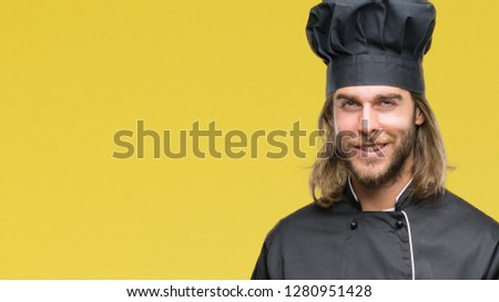 Young handsome cook man with long hair over isolated background cheerful with a smile of face pointing with hand and finger up to the side with happy and natural expression on face 