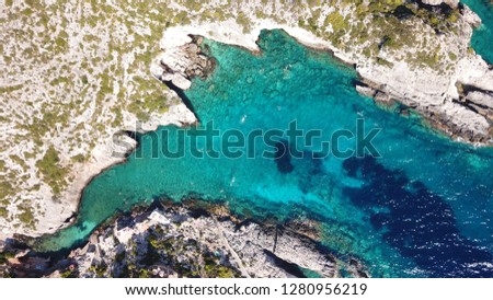 Aerial drone photo of tropical seascape with white rock volcanic caves and turquoise sea