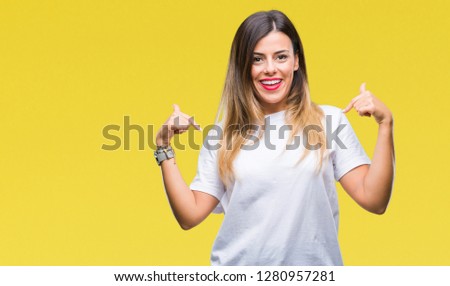 Young beautiful woman casual white t-shirt over isolated background looking confident with smile on face, pointing oneself with fingers proud and happy.