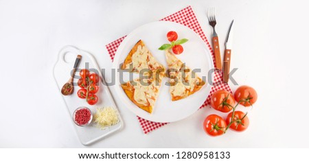 Sliced pizza with ingredients on white background. Top view, flat lay with copy space