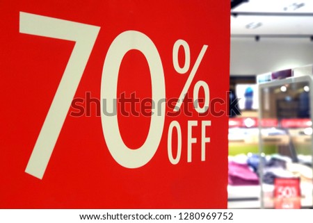 Large Sale 70% off letters on shopping mall board display, bokeh shopping mall as background.
