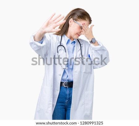 Middle age mature doctor woman wearing medical coat over isolated background covering eyes with hands and doing stop gesture with sad and fear expression. Embarrassed and negative concept.
