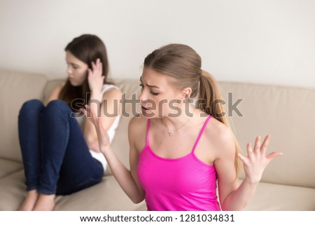 Angry young woman quarreling with girlfriend who ignores her, blames for misunderstanding and infamy, discussing relations. Female friends arguing about problem, cant reach agreement and understanding Royalty-Free Stock Photo #1281034831