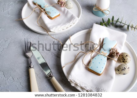 Homemade easter cookies in the shape of  a  funny  rabbit  on white plate. Easter  festive table setting. Holiday decorations.