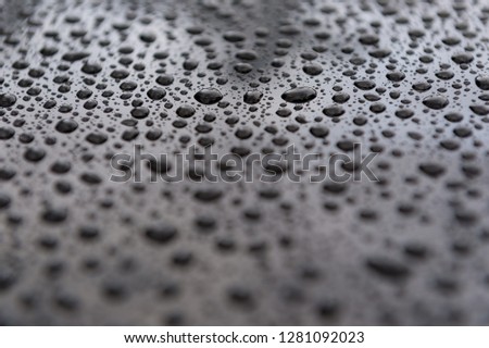 Water drops on a shiny roof of the car - depth of field