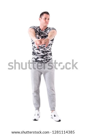 Athletic fit sport man stretching arms warming up and preparing for workout. Full body isolated on white background. 
