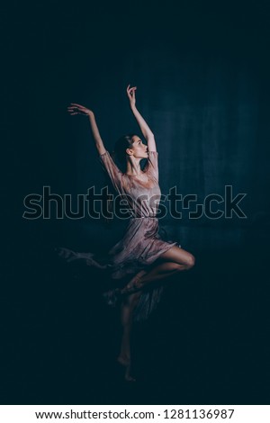 Ballerina performs the movement grand batt