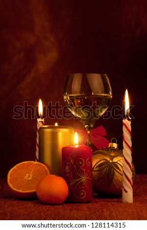 Christmas decoration glass with champagne and burning candles