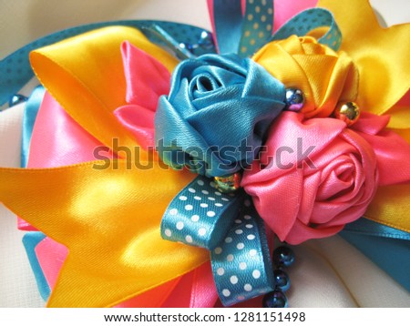 decoration of bows and flowers from satin ribbons