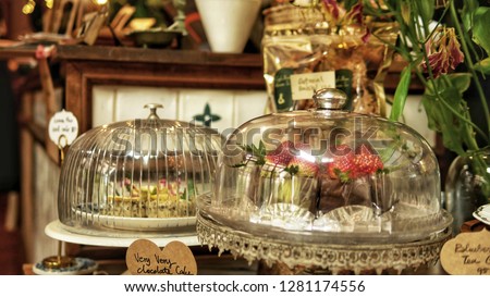 Bakery in a glass dome. Chocolate lava cake and put on display in the cafe. Brownies, lay a wooden floor. Vintage style. Cake. displayed in glass bell. Vintage effect style pictures.