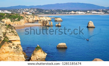 Seascape aerial with one lonely boat in Lagos, Algarve, Portugal