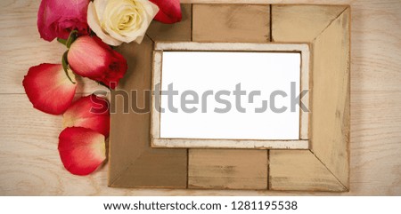 Empty photo frame and rose flower
