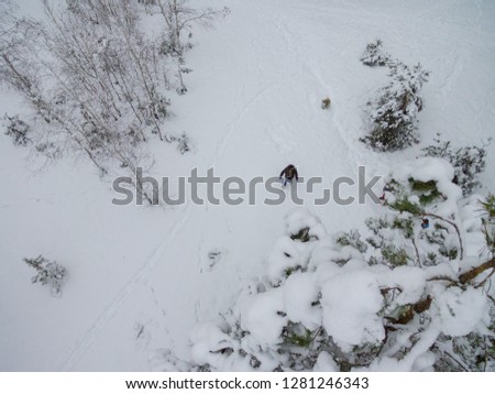 girl in the winter lies in the snow, the view from the drone