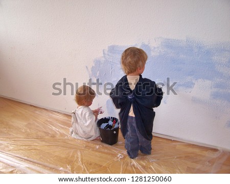 children painting a wall