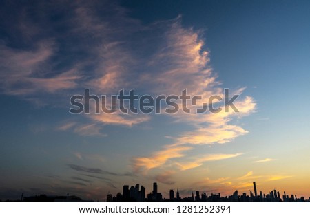 Silhouette of New York skyline during sunset.