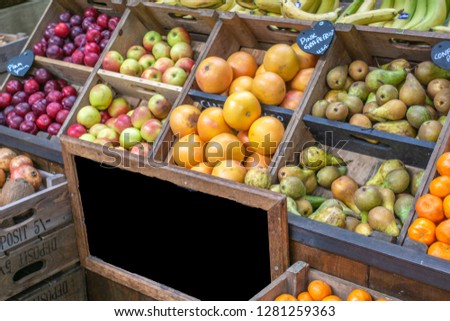 Fruits and vegetables at a farmers market with Blank sign for copy