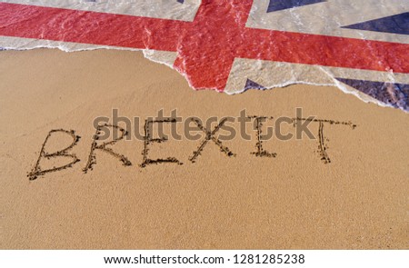 Handwrite text Brexit on sand coastline and foam wave with Great Britain flag pattern. On referendum, voted to exit United Kingdom from EU knows as Brexit, which is expected on March 29, 2019 Royalty-Free Stock Photo #1281285238