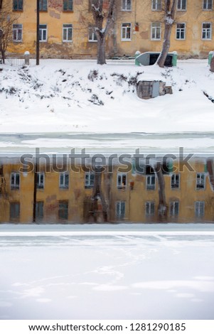 Torzhok city. Winter landscape with a reflection of the urban building in the river water. River Tvertsa