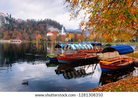 Beautiful landscape of Bled Lake and Pletna boats in Slovenia. Travel in Europe