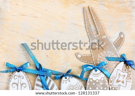 Easter eggs and rabbit  on wooden background /Easter card with bunny and eggs