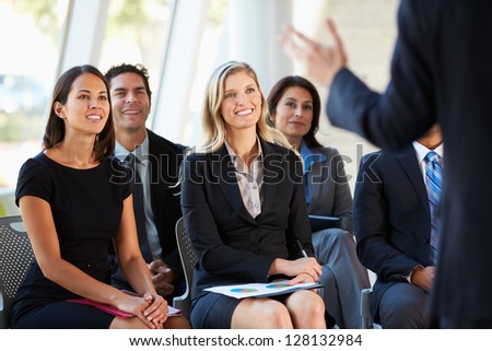 Audience Listening To Presentation At Conference Royalty-Free Stock Photo #128132984
