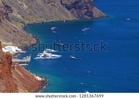  Motorboats and sailing ship in the sea of Santorini, Greece