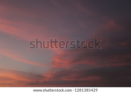 nature horizontal photography: dramatic scenic sunset over Atlantic ocean, with a blue. pink, purple, violet, yellow, orange and red sky, outdoors in the Gambia, Africa with room for text