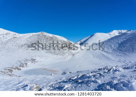 Snow landscape with a frozen lake in Velouchi mountain at Evritania, Greece