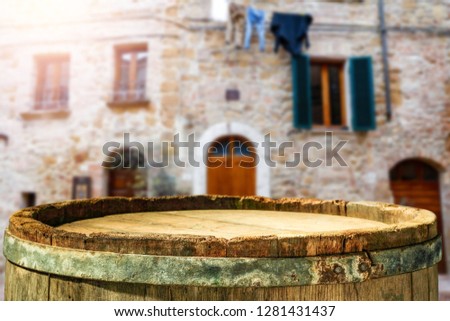 wooden barrel as a table with a free space for an advertising product, the hero on the background of the landscape