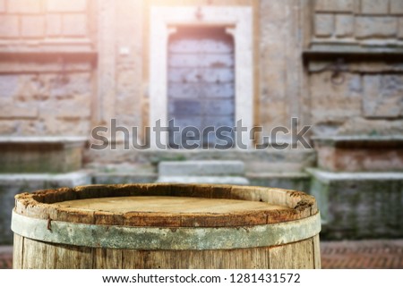 wooden barrel as a table with a free space for an advertising product, the hero on the background of the landscape