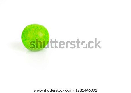 Sweet green candy lies on a white background
