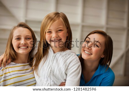Portrait of three smiling sisters.
