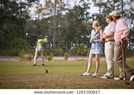 Friends playing golf