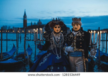 A mysterious couple with candles at the 2018 Venetian carnival.