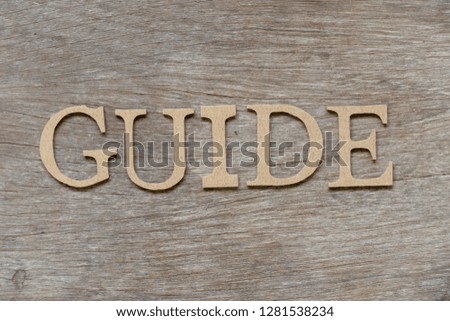 Alphabet letter in word guide on wood background