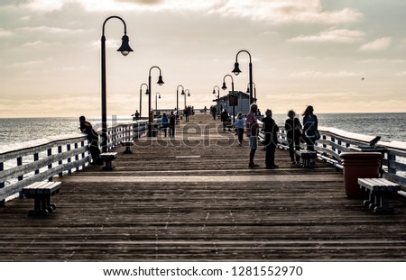 People walking on a pier in San Clemente, Orange County, Southern California.