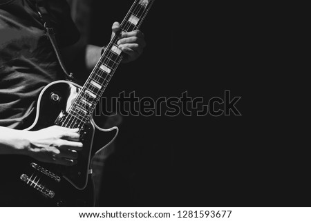 Guitarist on stage for background, soft and blur concept. Close up hand playing guitar. young musician playing guitar, live music background.Band performs on stage, rock music concert. Royalty-Free Stock Photo #1281593677