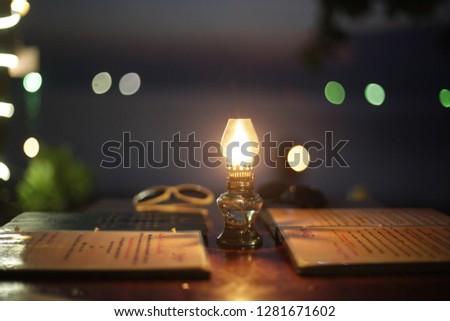 Retro Style Vintage Cafe Table With Menu and lantern on a tropical beach