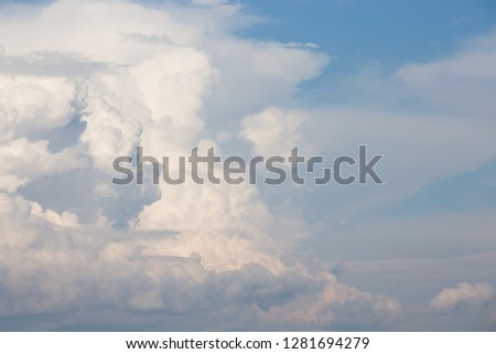 Beautiful fluffy clouds on a blue sky background