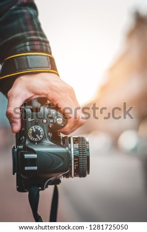 Man hipster, Professional photographer landscape with dslr camera in hands for ready to take pictures, Photographers takes snapshots for pleasure to remember events, vintage tone 