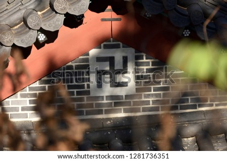 A sign used to symbolize Buddhism. Selective focus symbol and soft focus.