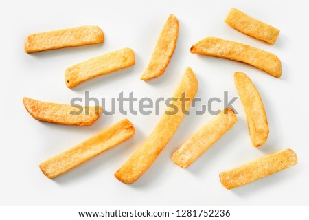 Homemade deep fried French fries on a white background in a random scatter viewed from above