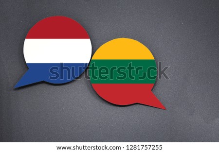 Netherlands and Lithuania flags with two speech bubbles on dark gray background