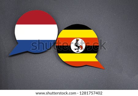 Netherlands and Uganda flags with two speech bubbles on dark gray background