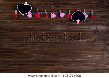 Red heart message with chalk card with red hearts on brown wooden background. Valentines Day concept